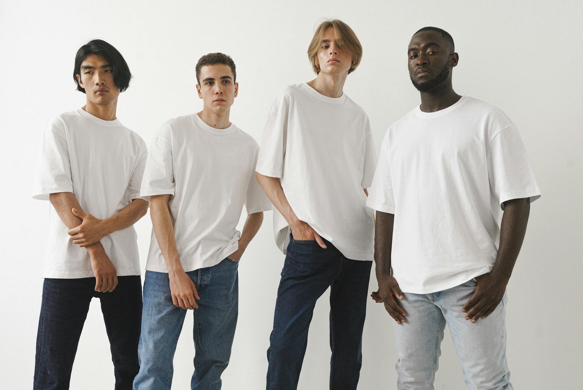 men posing in white t shirts and jeans